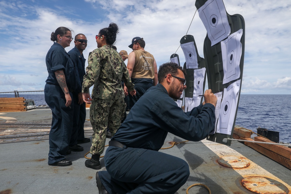 Sailors aboard the USS Howard conduct a small arms gunshoot in the South China Sea