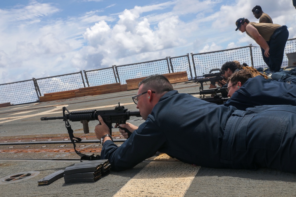 Sailors aboard the USS Howard conduct a small arms gunshoot in the South China Sea