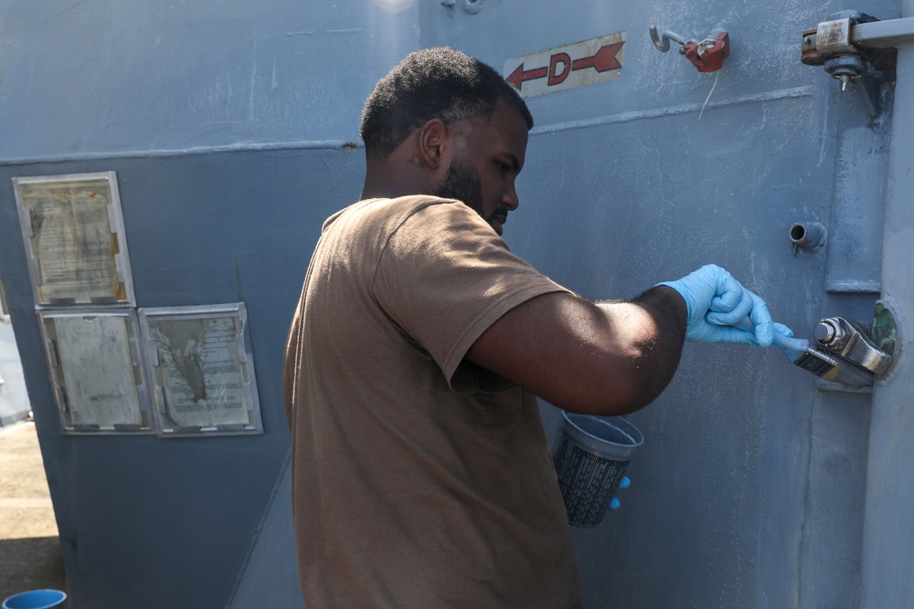 Sailors aboard the USS Howard conduct ship preservation efforts in the South China Sea