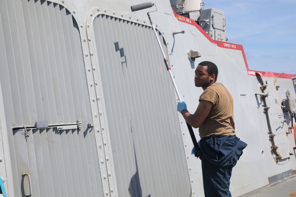 Sailors aboard the USS Howard conduct ship preservation efforts in the South China Sea