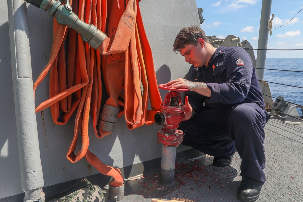 Sailors aboard the USS Howard conduct ship preservation efforts in the South China Sea