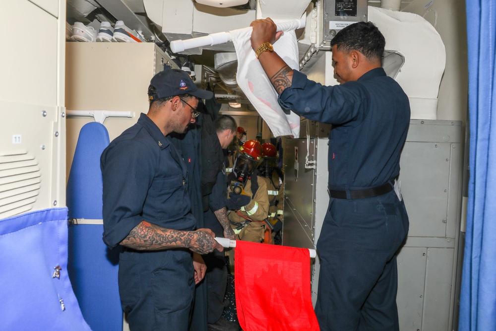 Sailors aboard the USS Howard conduct an integrated training team drill in the South China Sea