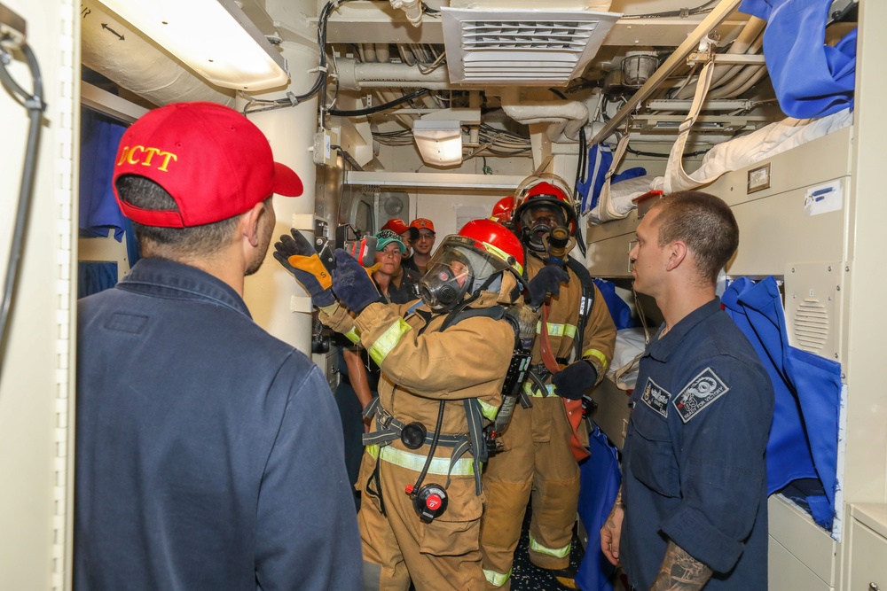 Sailors aboard the USS Howard conduct an integrated training team drill in the South China Sea