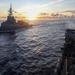 Sailors aboard the USS Howard wave farewell to the HMAS Sydney V in the South China Sea