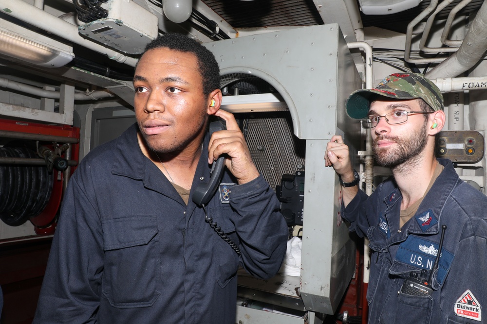 Sailors aboard the USS Howard conduct an engineering training team drill in the South China Sea