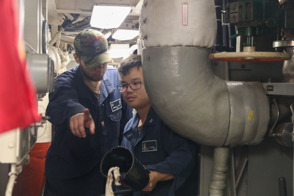 Sailors aboard the USS Howard conduct an engineering training team drill in the South China Sea