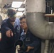 Sailors aboard the USS Howard conduct an engineering training team drill in the South China Sea