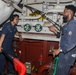 Sailors aboard the USS Howard conduct an engineering training team drill in the South China Sea