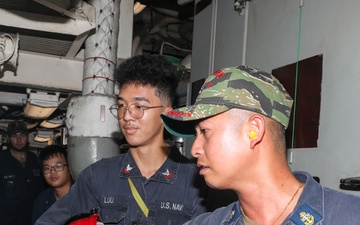 Sailors aboard the USS Howard conduct an engineering training team drill in the South China Sea