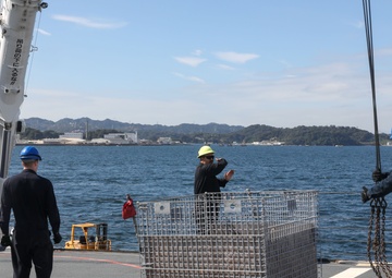 Sailors aboard the USS Howard conduct an ammo offload in Yokosuka, Japan