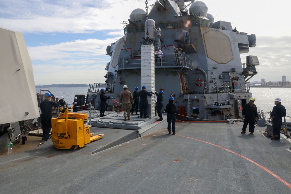 Sailors aboard the USS Howard conduct an ammo offload in Yokosuka, Japan