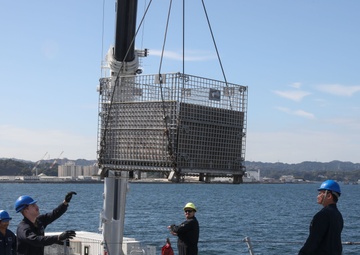 Sailors aboard the USS Howard conduct an ammo offload in Yokosuka, Japan
