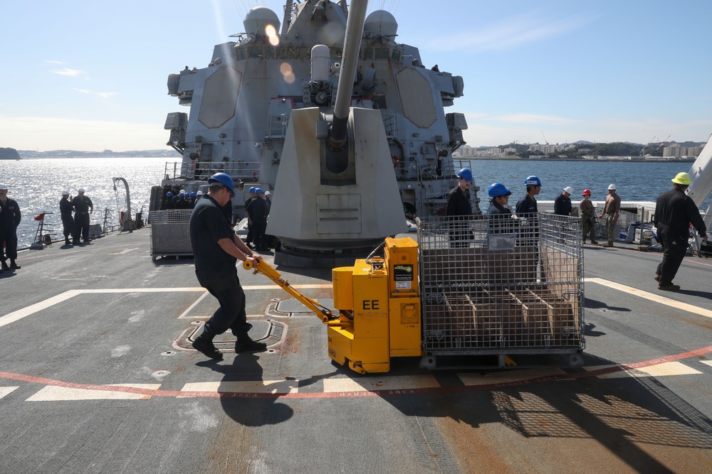 Sailors aboard the USS Howard conduct an ammo offload in Yokosuka, Japan