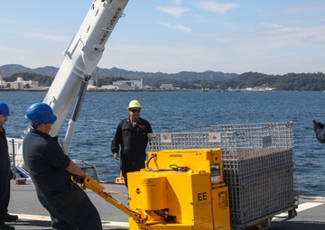 Sailors aboard the USS Howard conduct an ammo offload in Yokosuka, Japan