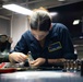 Sailors fabricate a metal patch aboard USS George Washington