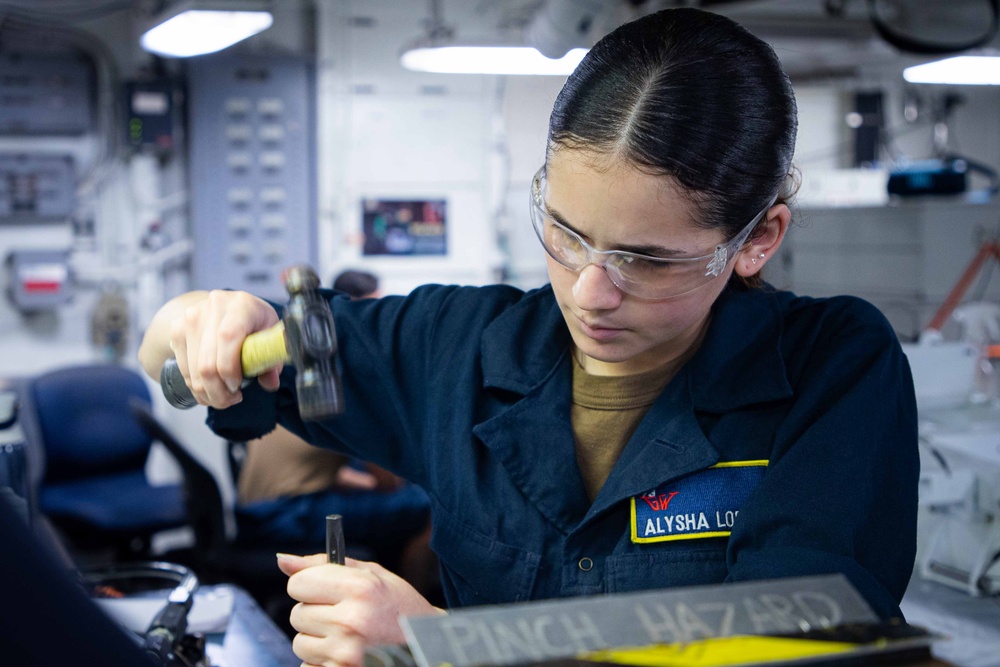Sailors fabricate a metal patch aboard USS George Washington