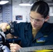 Sailors fabricate a metal patch aboard USS George Washington