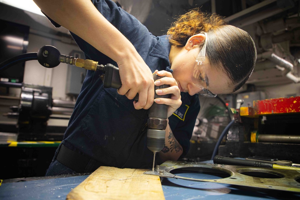 Sailors fabricate a metal patch aboard USS George Washington