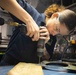Sailors fabricate a metal patch aboard USS George Washington