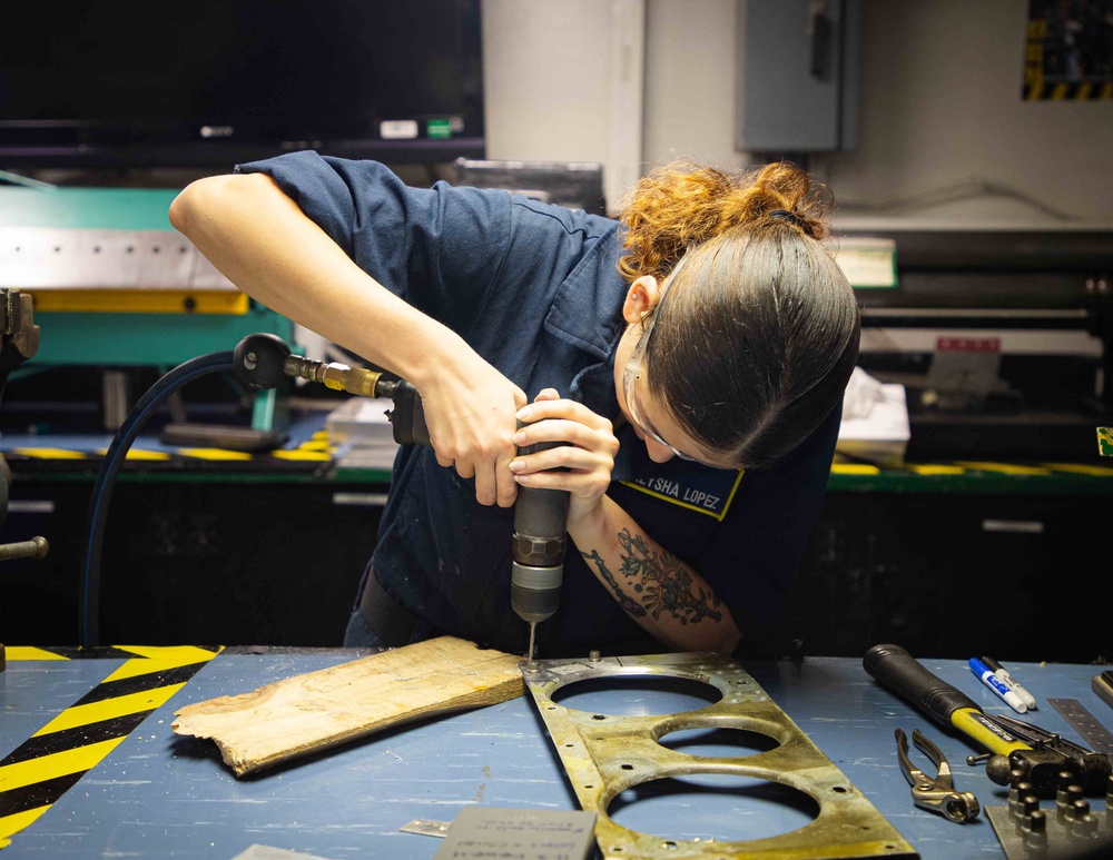 Sailors fabricate a metal patch aboard USS George Washington