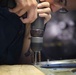 Sailors fabricate a metal patch aboard USS George Washington