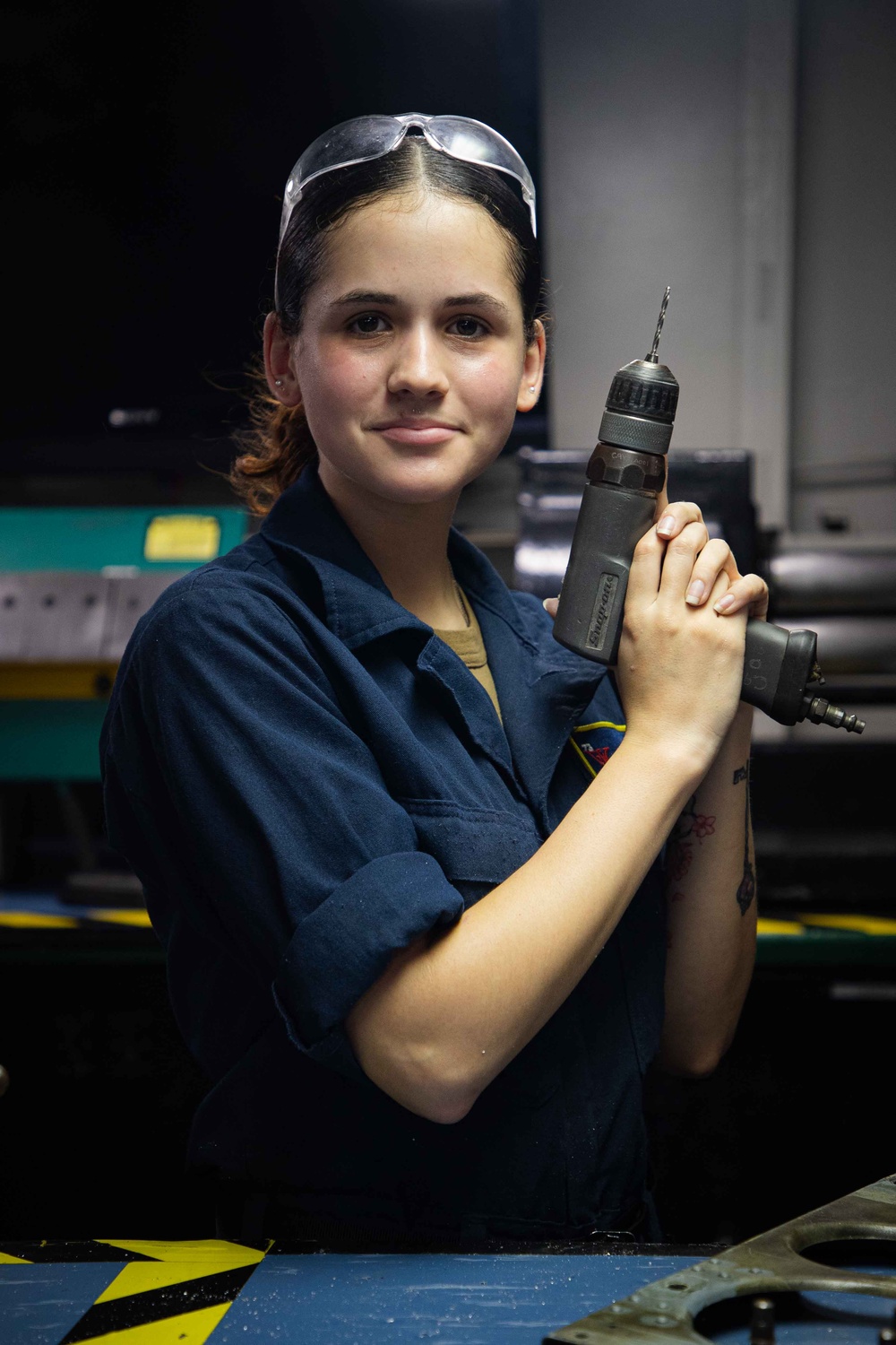 Sailors fabricate a metal patch aboard USS George Washington