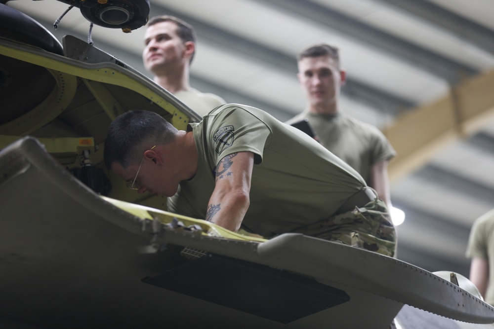 An Aircraft Mechanic inspects a CH-47 Chinook