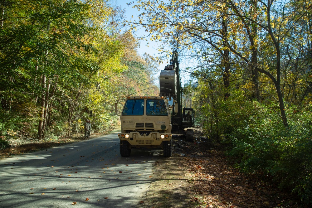 Tennessee Army National Guardsmen clear debris on Hartford Road in Cocke County, Tennessee