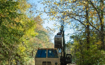 Tennessee Army National Guardsmen clear debris on Hartford Road in Cocke County, Tennessee