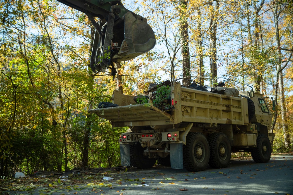 Tennessee Army National Guardsmen clear debris on Hartford Road in Cocke County, Tennessee