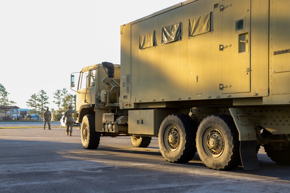 Sustainment Soldiers Conduct preventative maintenance check on M1087 Expandable Van Shelter