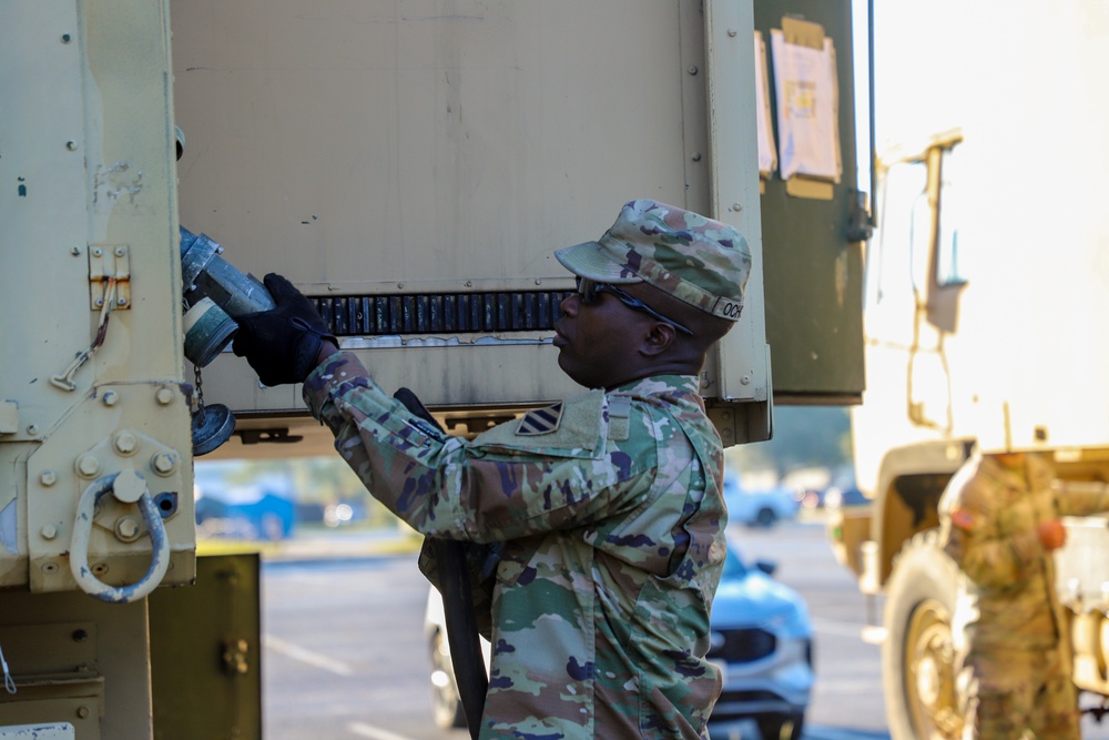 Sustainment Soldiers Conduct preventative maintenance check on M1087 Expandable Van Shelter