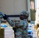 Sustainment Soldiers Conduct preventative maintenance check on M1087 Expandable Van Shelter