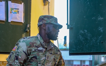 Sustainment Soldiers Conduct preventative maintenance check on M1087 Expandable Van Shelter