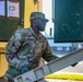 Sustainment Soldiers Conduct preventative maintenance check on M1087 Expandable Van Shelter