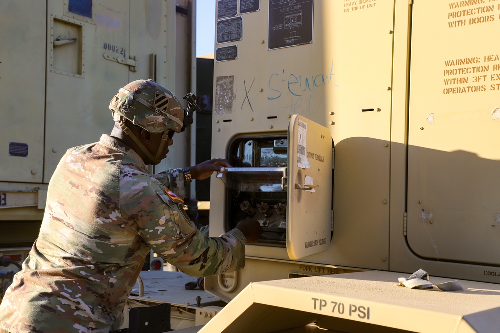 Sustainment Soldiers Conduct preventative maintenance check on M1087 Expandable Van Shelter