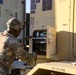 Sustainment Soldiers Conduct preventative maintenance check on M1087 Expandable Van Shelter