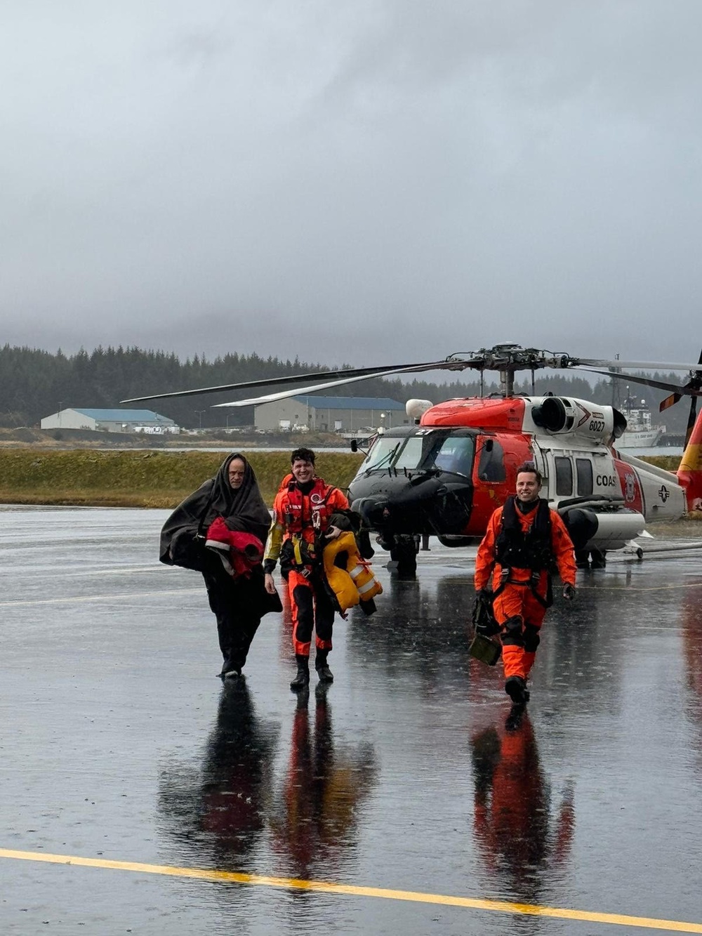 Coast Guard helicopter crew and survivors return from rescue mission