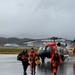 Coast Guard helicopter crew and survivors return from rescue mission