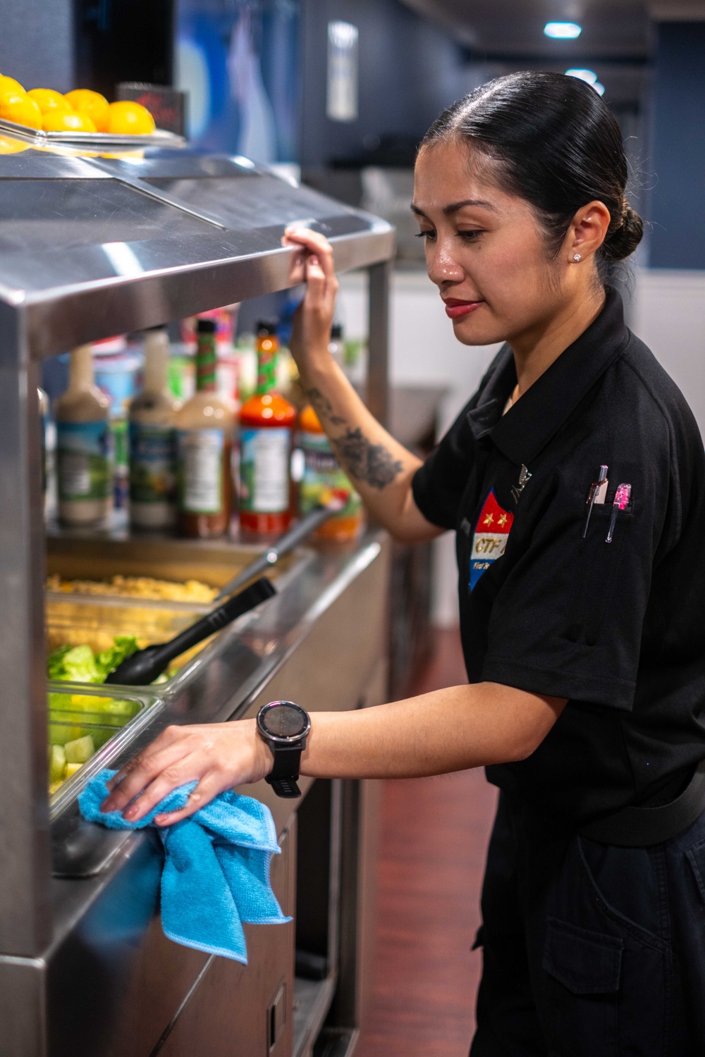 Commander, Task Force 70 (CTF 70) Sailor maintains cleanliness of flag mess