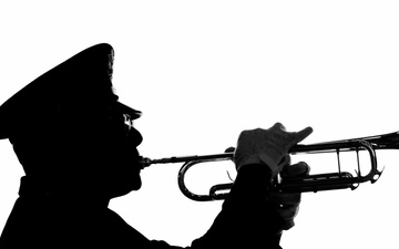 Chaplain Performs Taps at Memorial Service