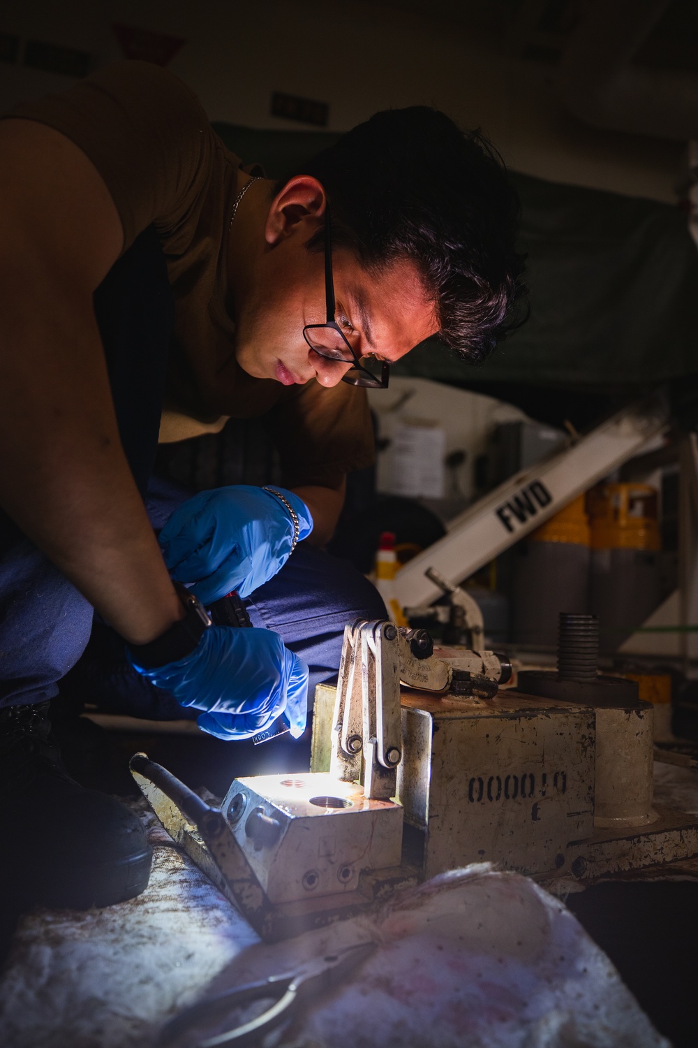 AIMD Sailors disassemble axle jack aboard USS George Washington