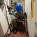 Sailor perfoms deck work