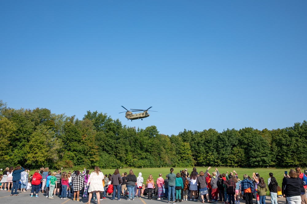 A CH-47 Chinook approaches an elementary school