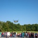 A CH-47 Chinook approaches an elementary school