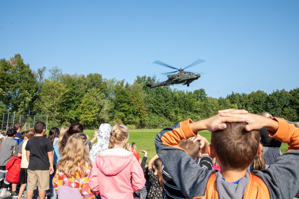 An AH-64D Apache Approaches an Elementary School