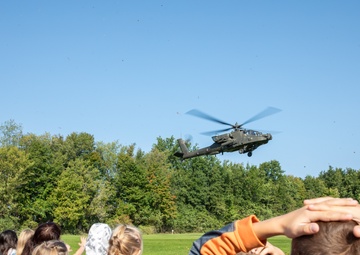 An AH-64D Apache Approaches an Elementary School