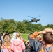 An AH-64D Apache Approaches an Elementary School