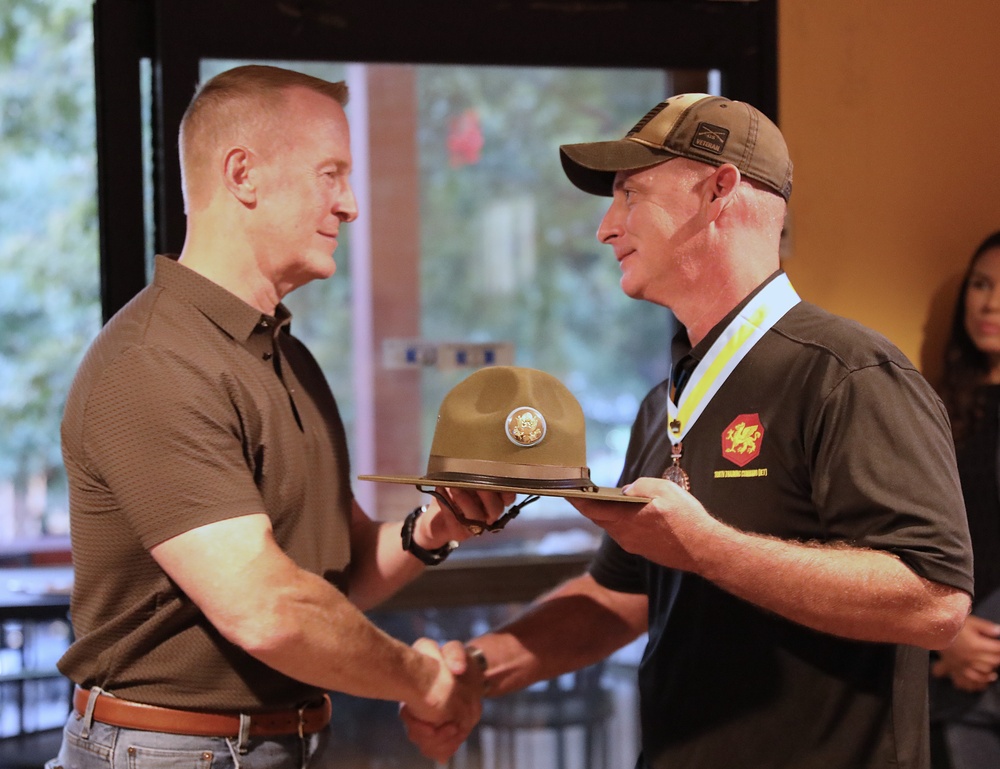 Sgt. Maj. Mooso gifts MG Dyer with Drill Sergeant Hat