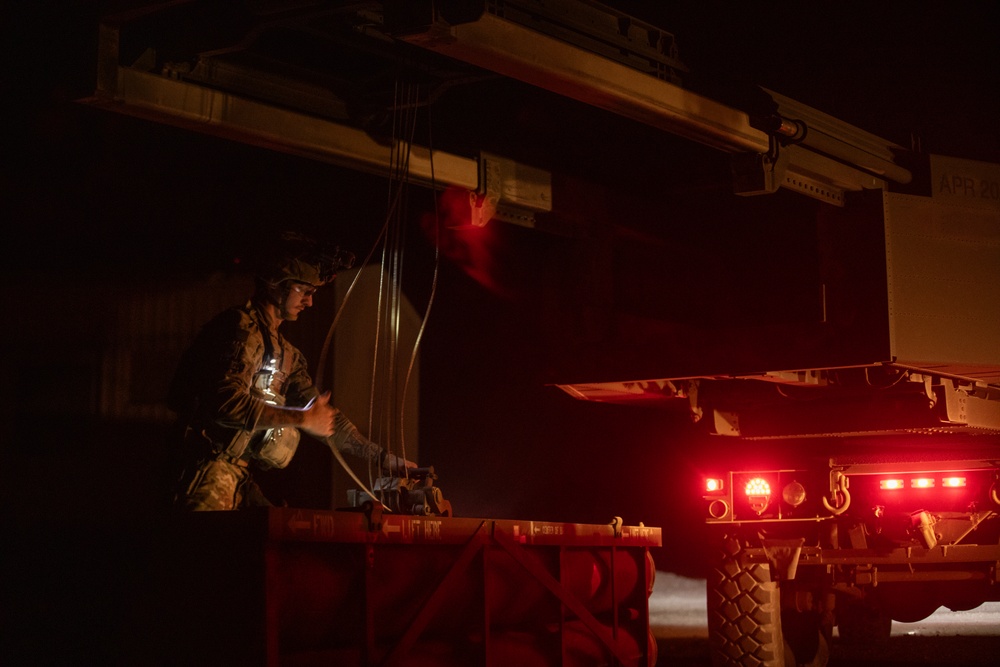 Soldiers load Guided Multiple Launch Rocket System (GMLRS) rockets